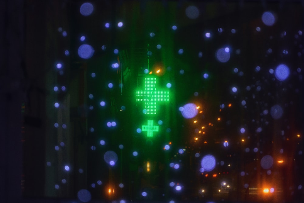 a green cross is lit up in the dark