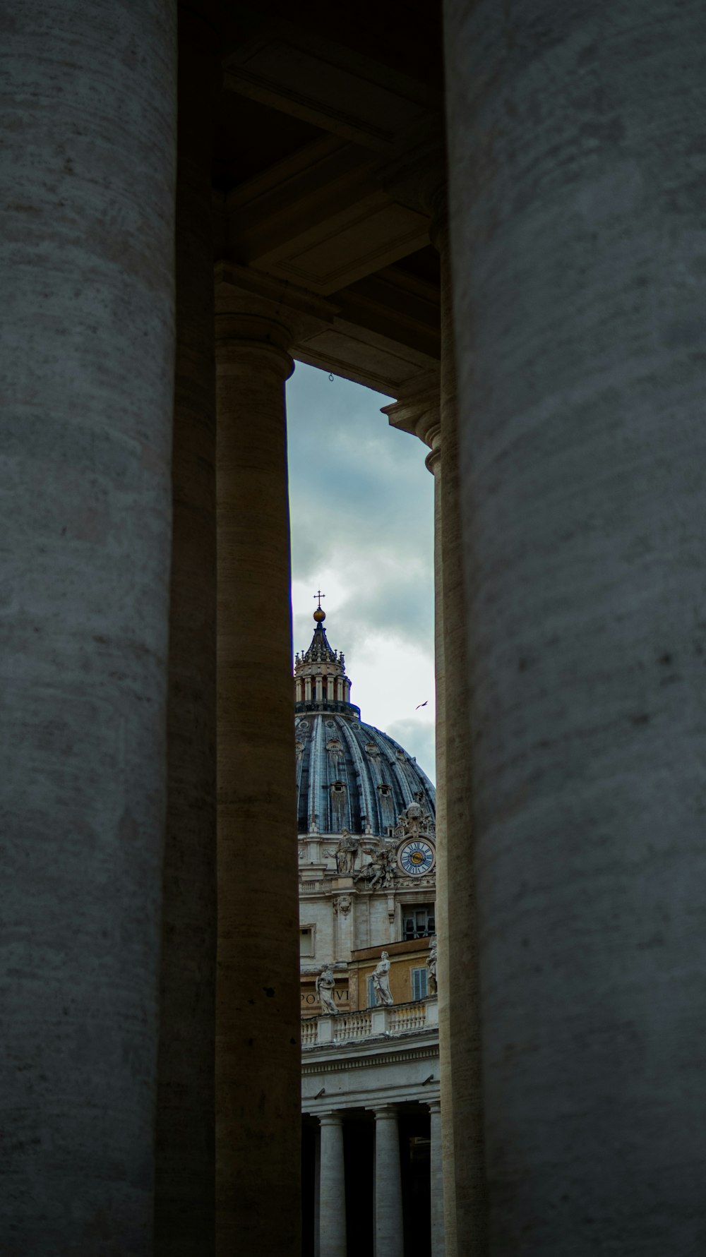 a view of a building through some pillars