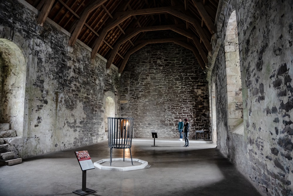 a room with a stone wall and a wooden ceiling