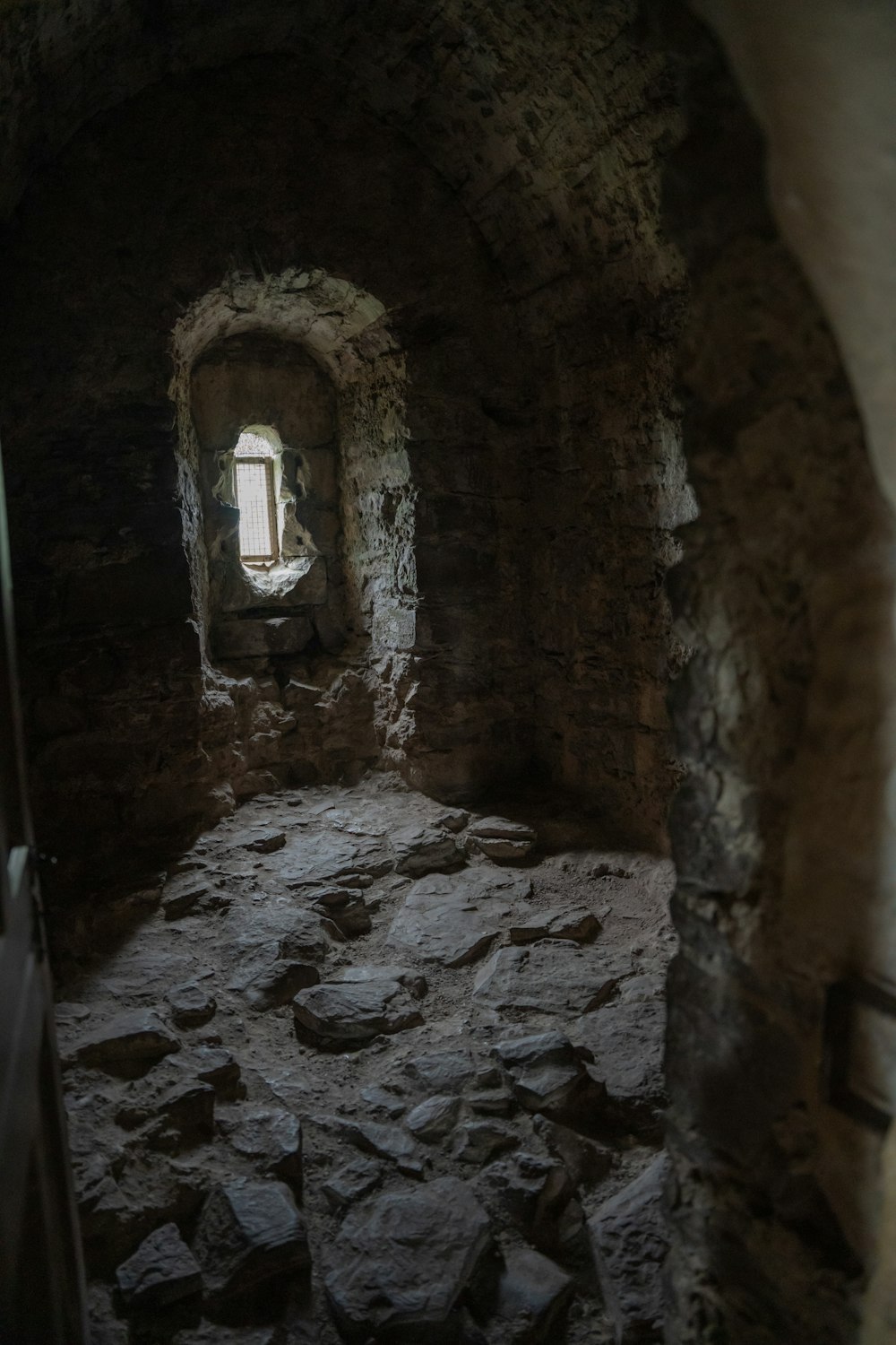 a stone tunnel with a window in it