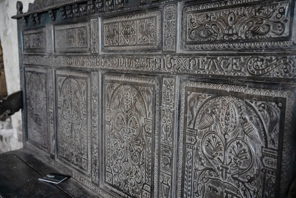 a wooden bench with intricate carvings on it