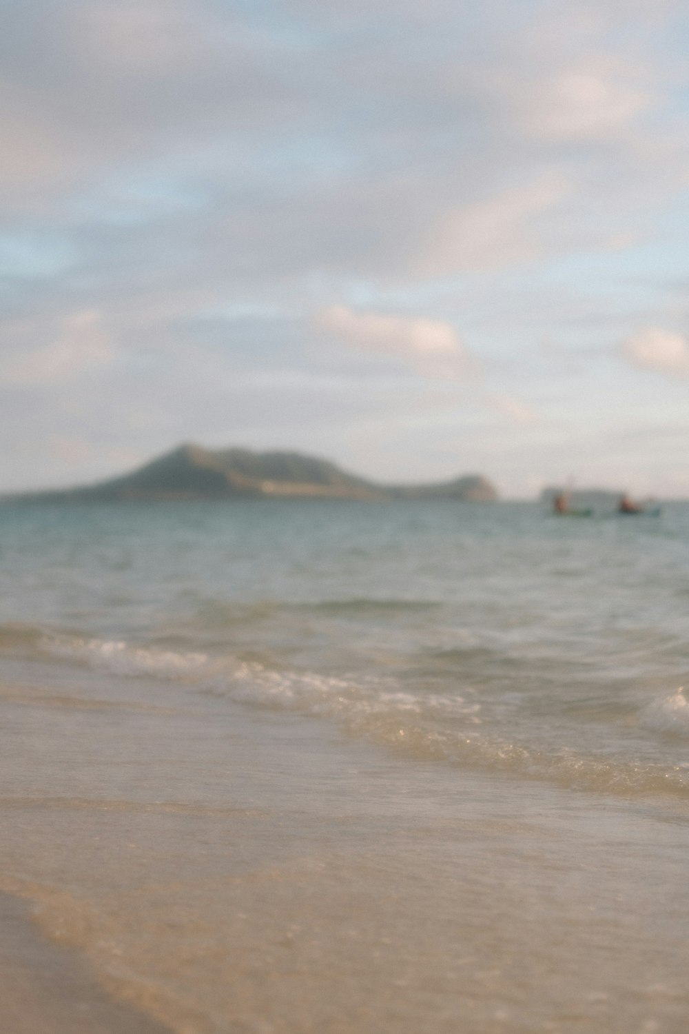 a person holding a surfboard on a beach