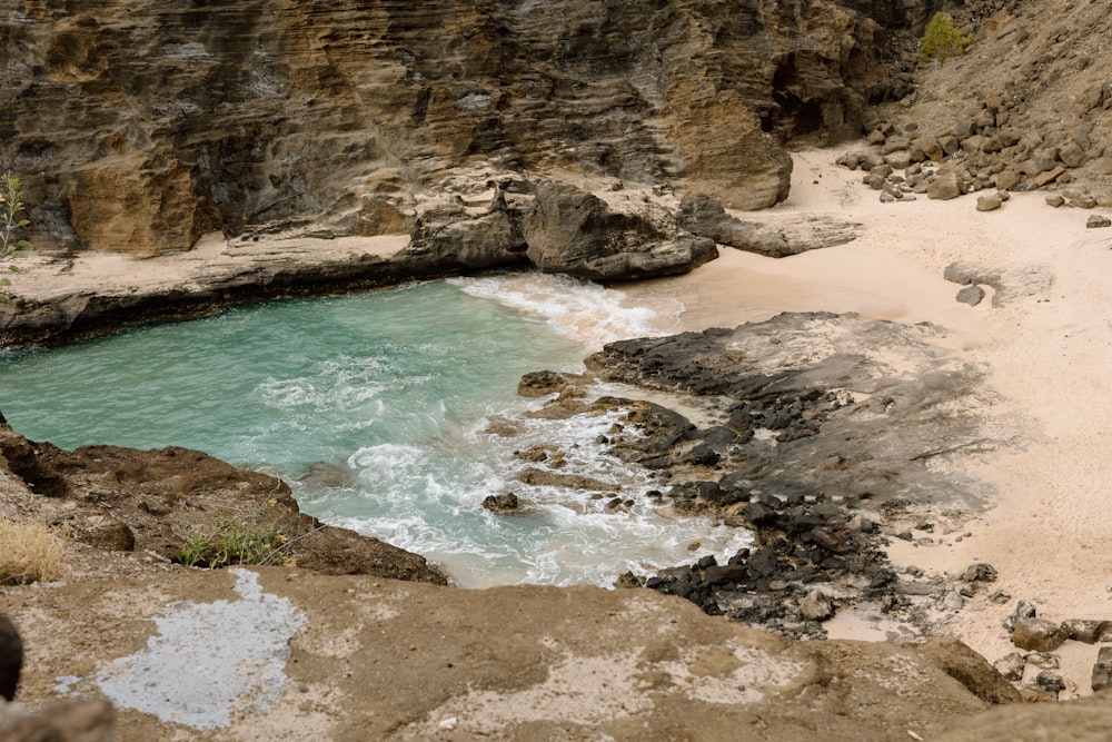 a body of water near a rocky cliff