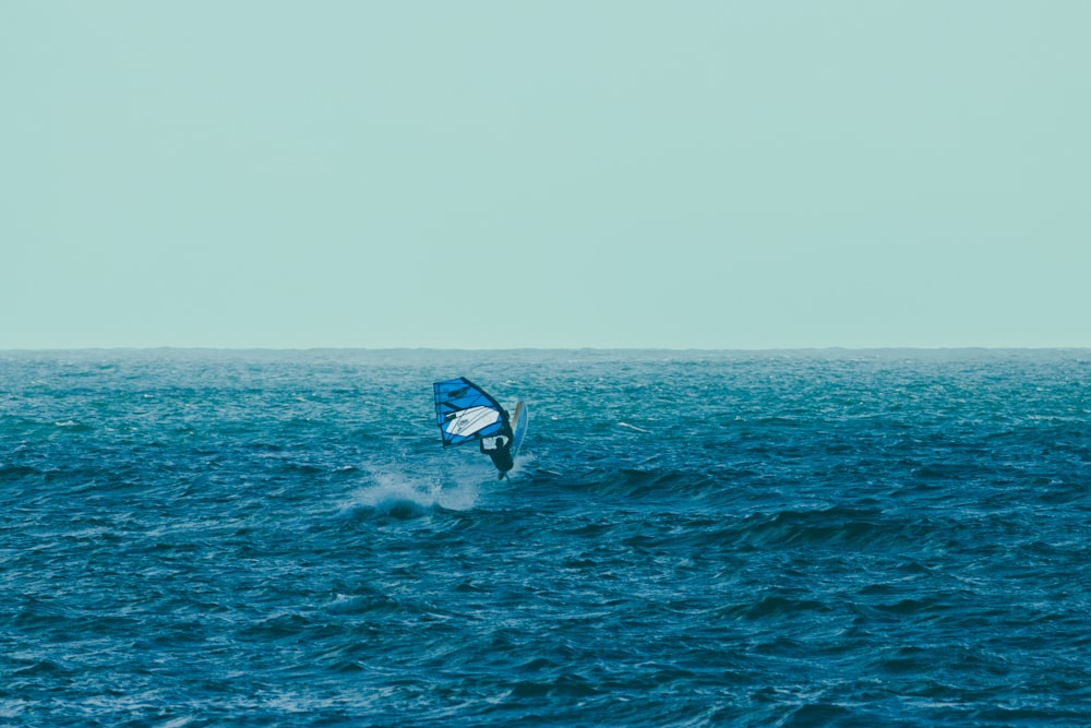 a person riding a surfboard on top of a body of water