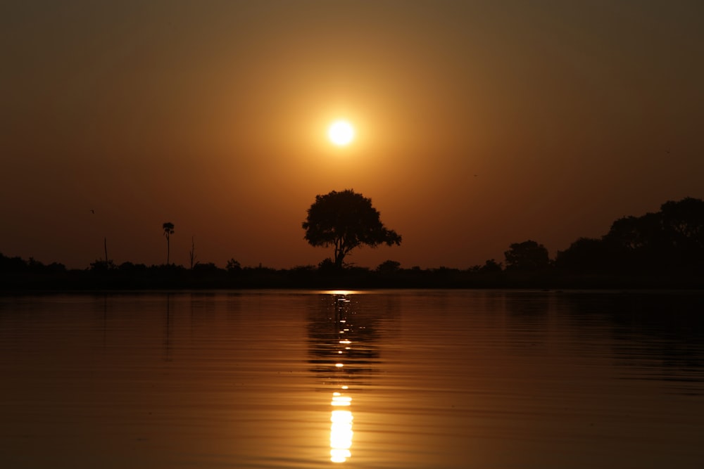 the sun is setting over a body of water