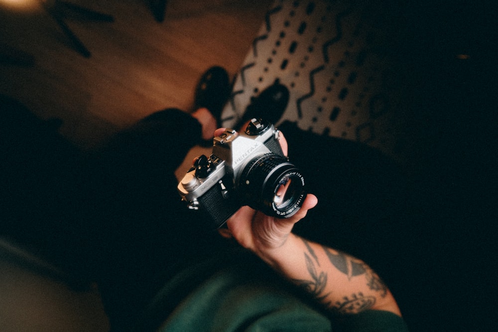 a person holding a camera in their hand