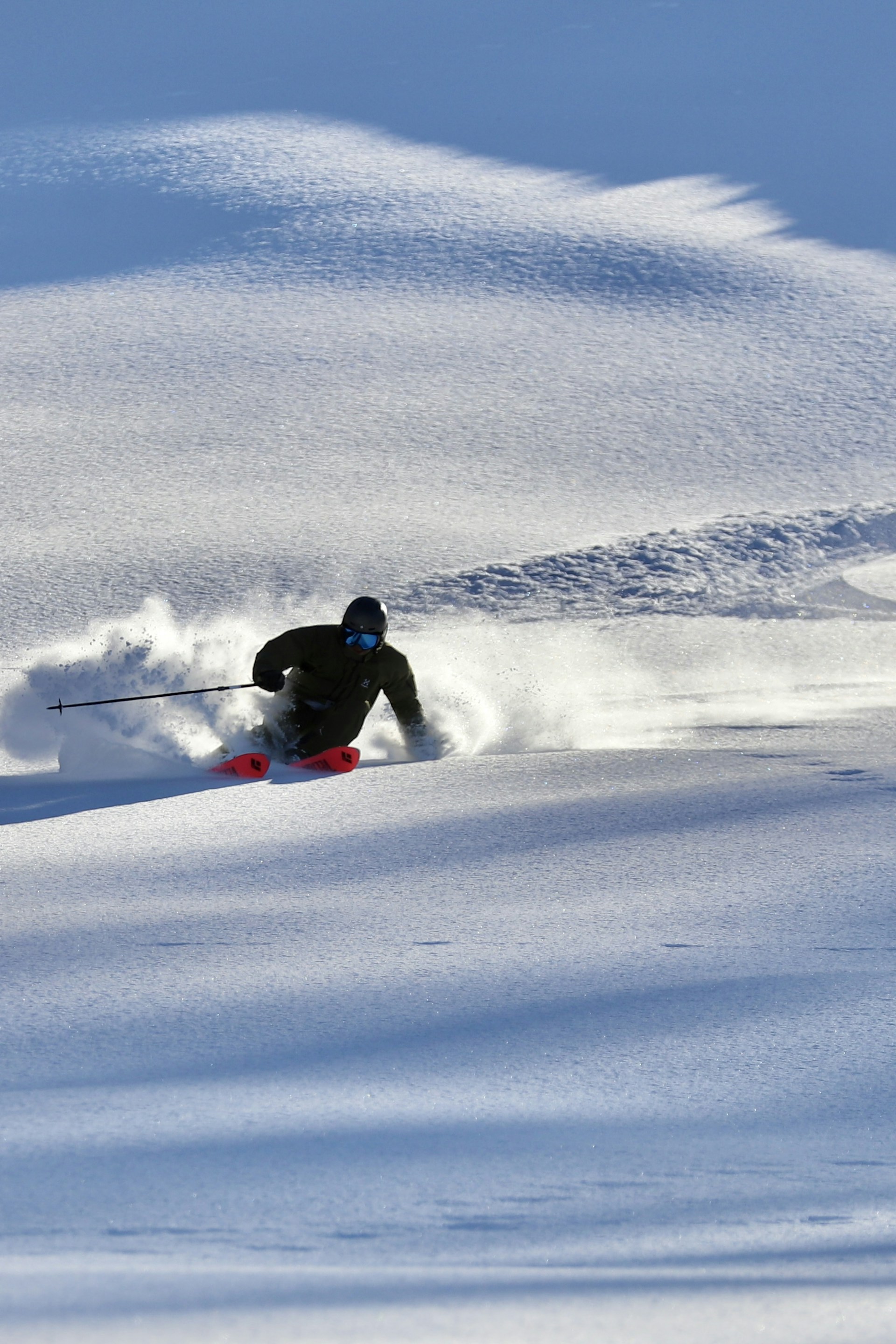 a man riding skis down a snow covered slope