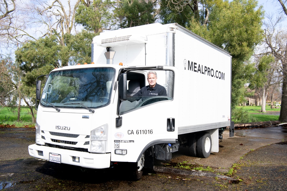 a man sitting in the driver's seat of a truck