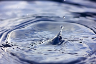 a close up of a water drop with a sky background