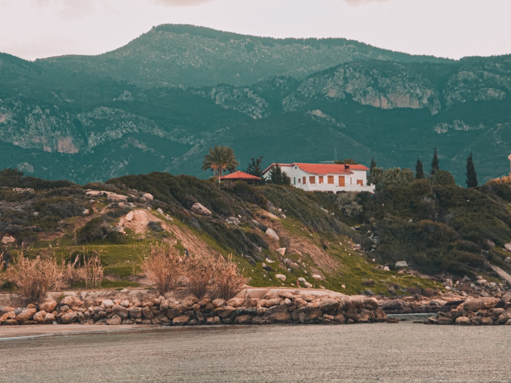 a house on a hill overlooking a body of water