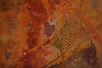 a close up of a painting with hearts on it