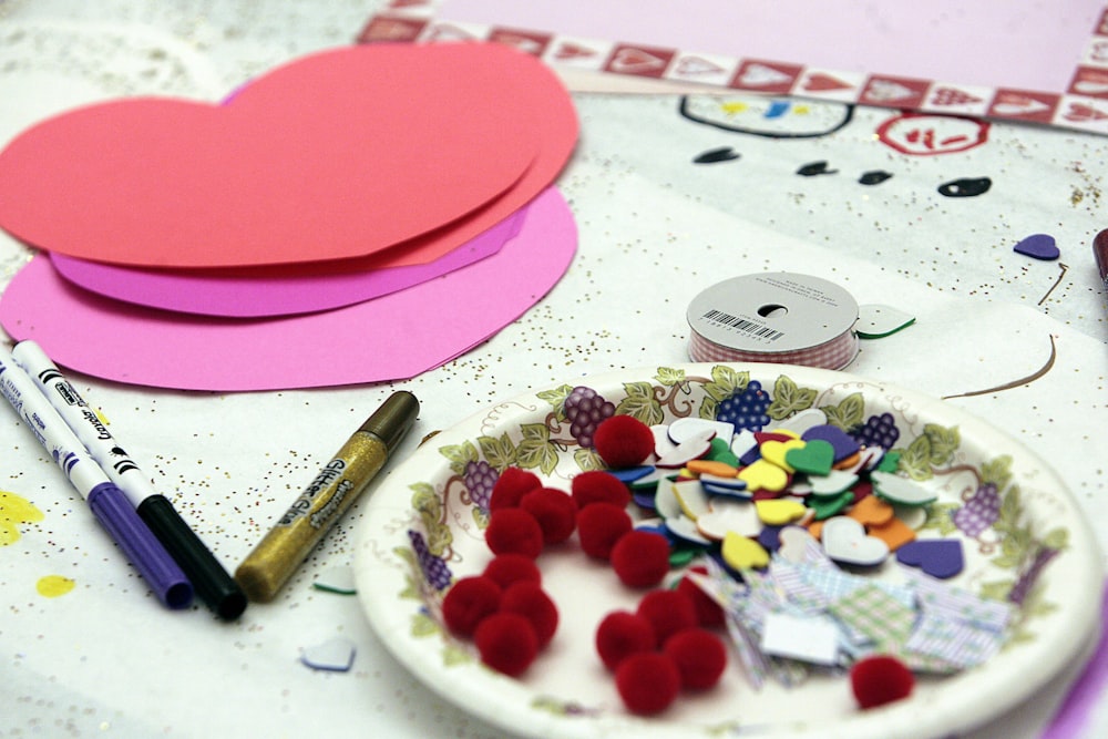 a table topped with lots of crafting supplies