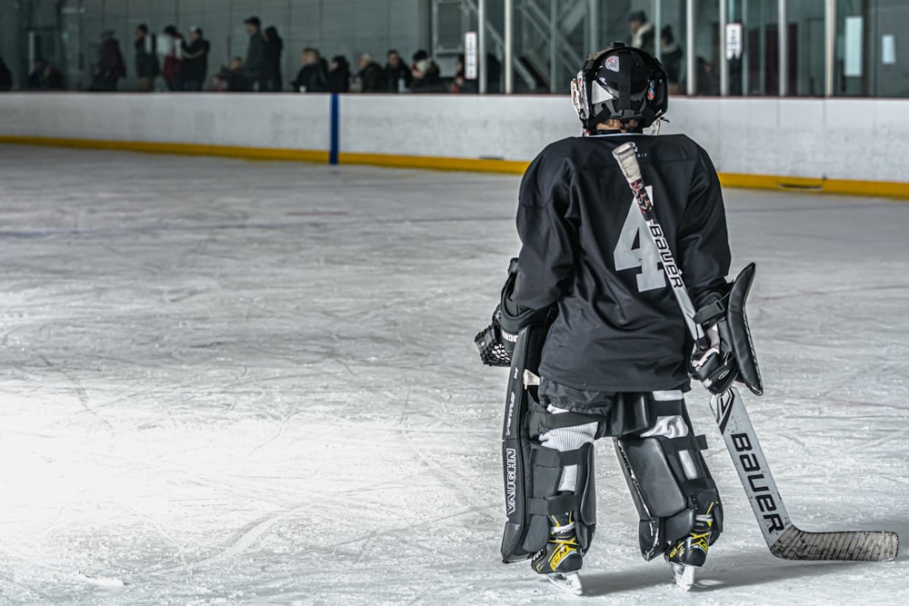 a hockey player is standing on the ice