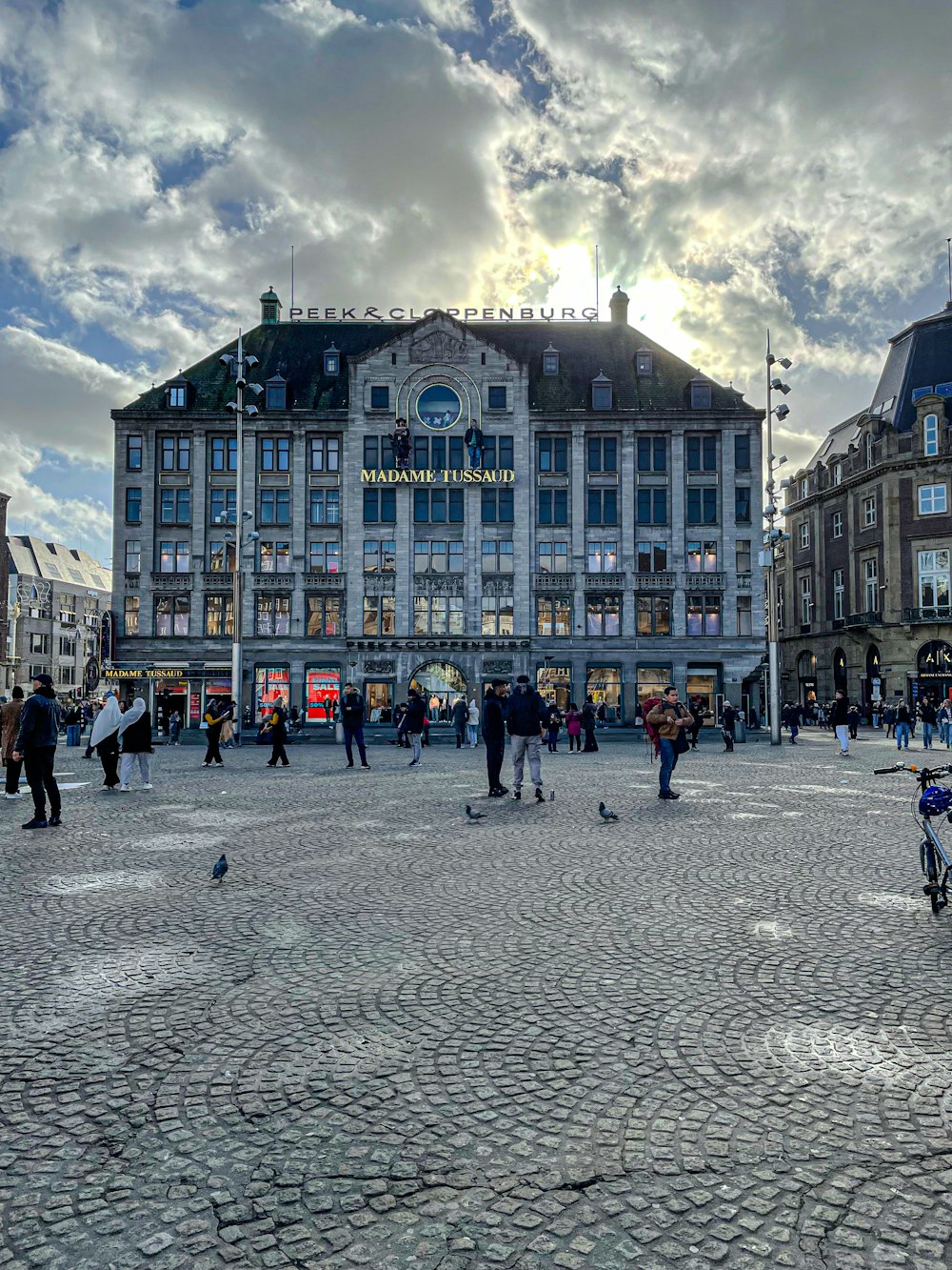 a group of people walking around a city square