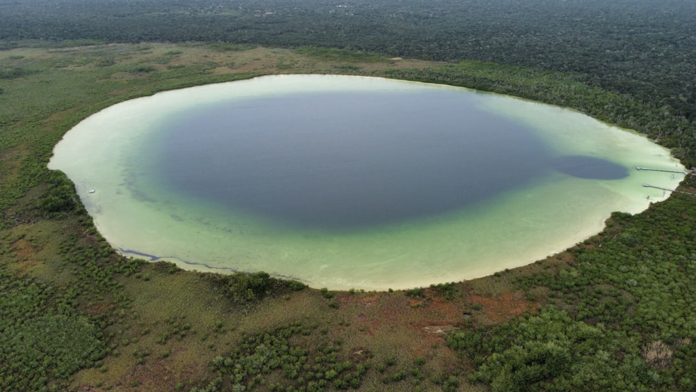 an aerial view of a large lake surrounded by trees