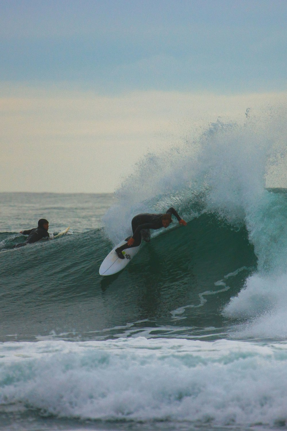 a man riding a wave on top of a surfboard