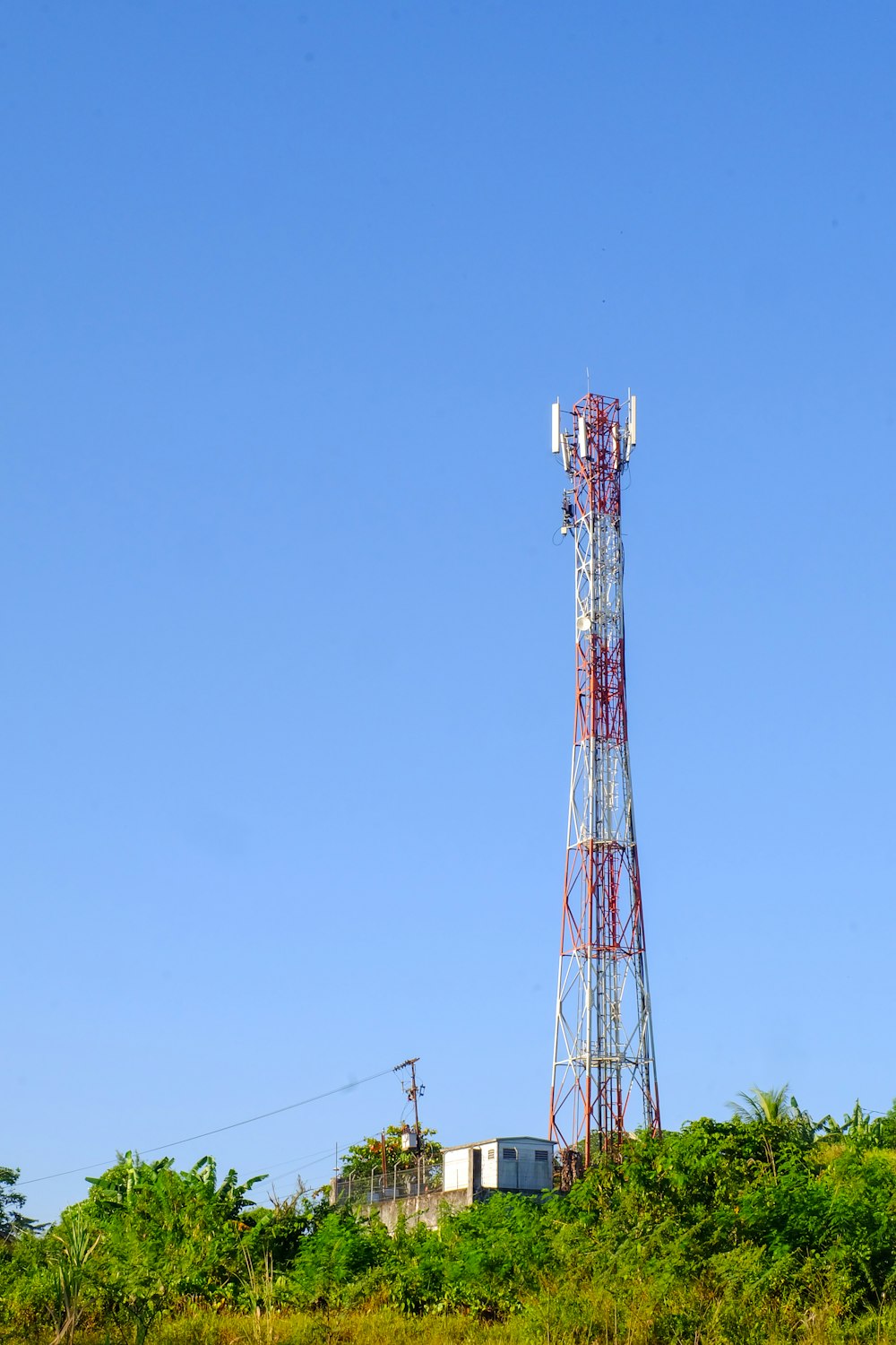 a tall tower sitting on top of a lush green hillside