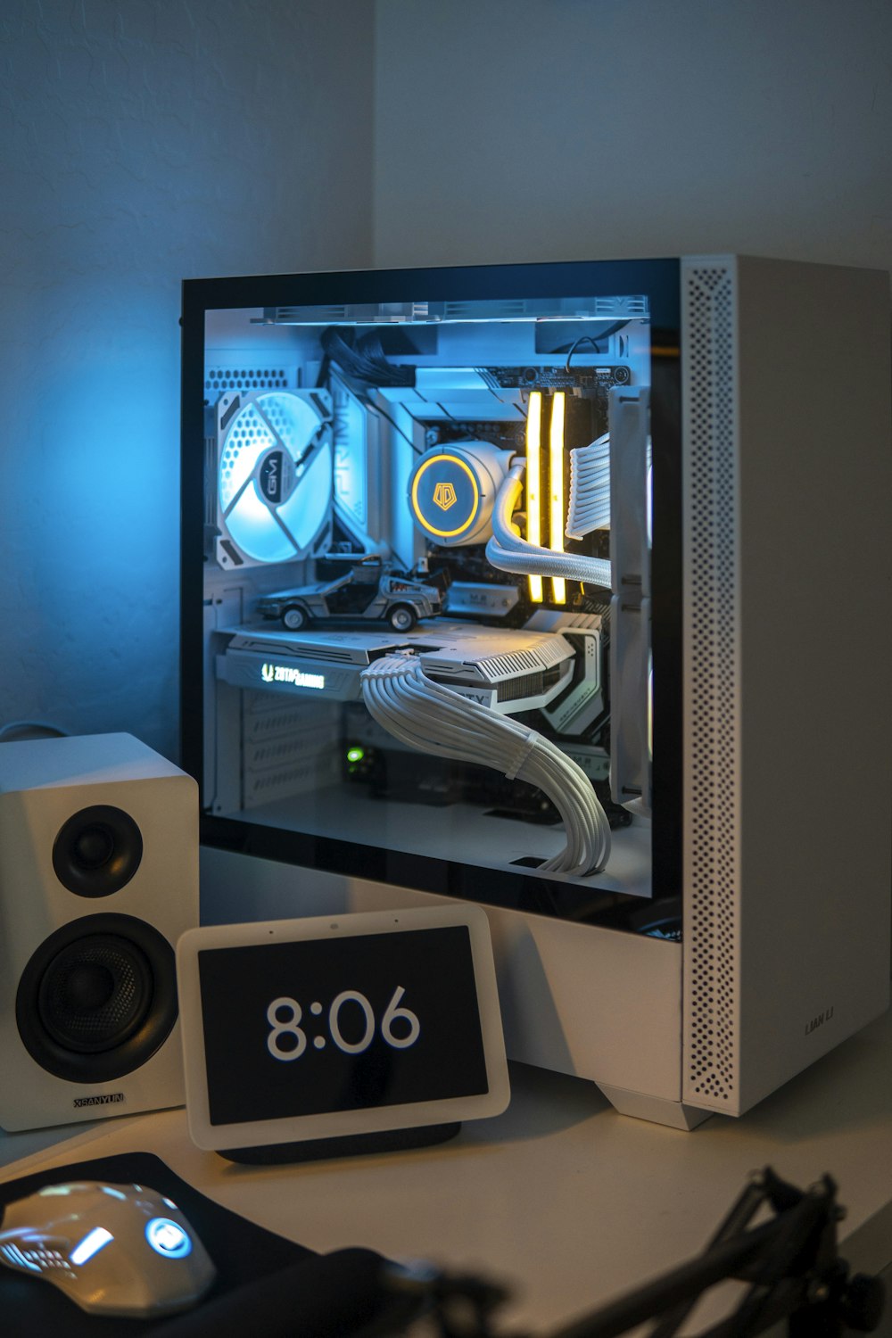 a desktop computer with a clock and speakers