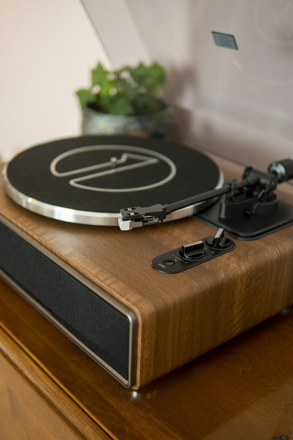 a record player sitting on top of a wooden table