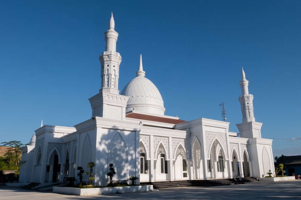 a large white building with two towers and a dome