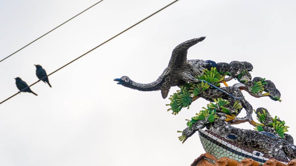 two birds sitting on top of a potted plant