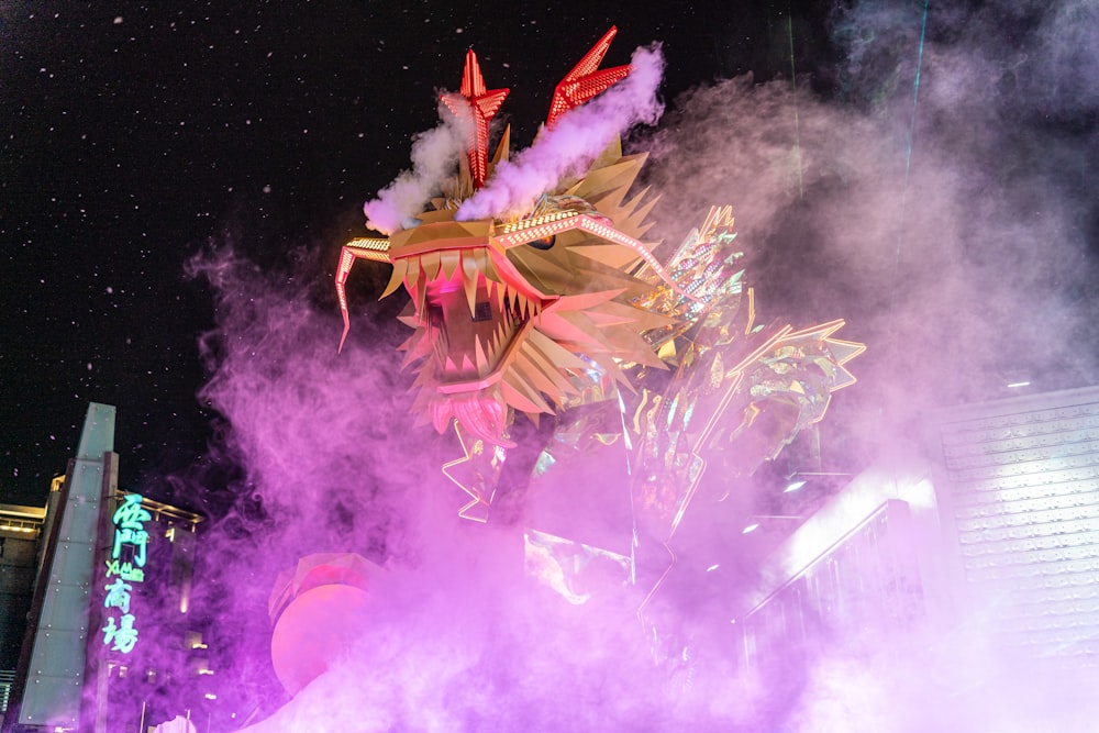 a dragon statue is surrounded by purple smoke