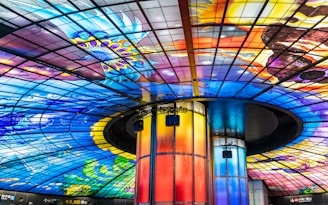 a colorful ceiling in a building with a glass ceiling