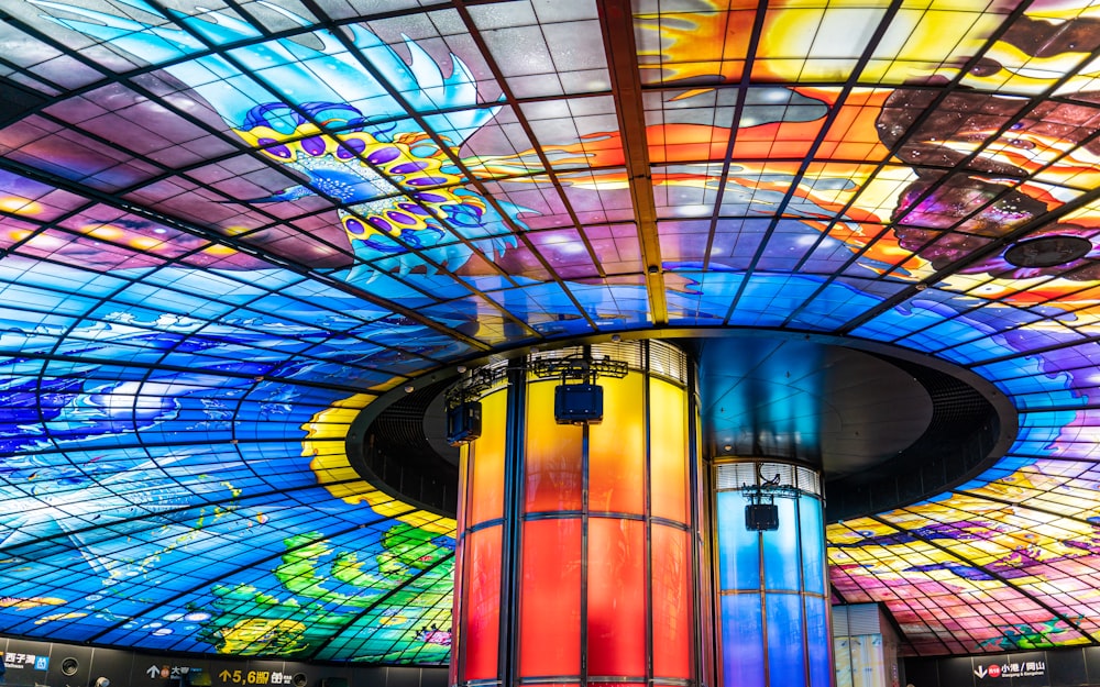a colorful ceiling in a building with a glass ceiling