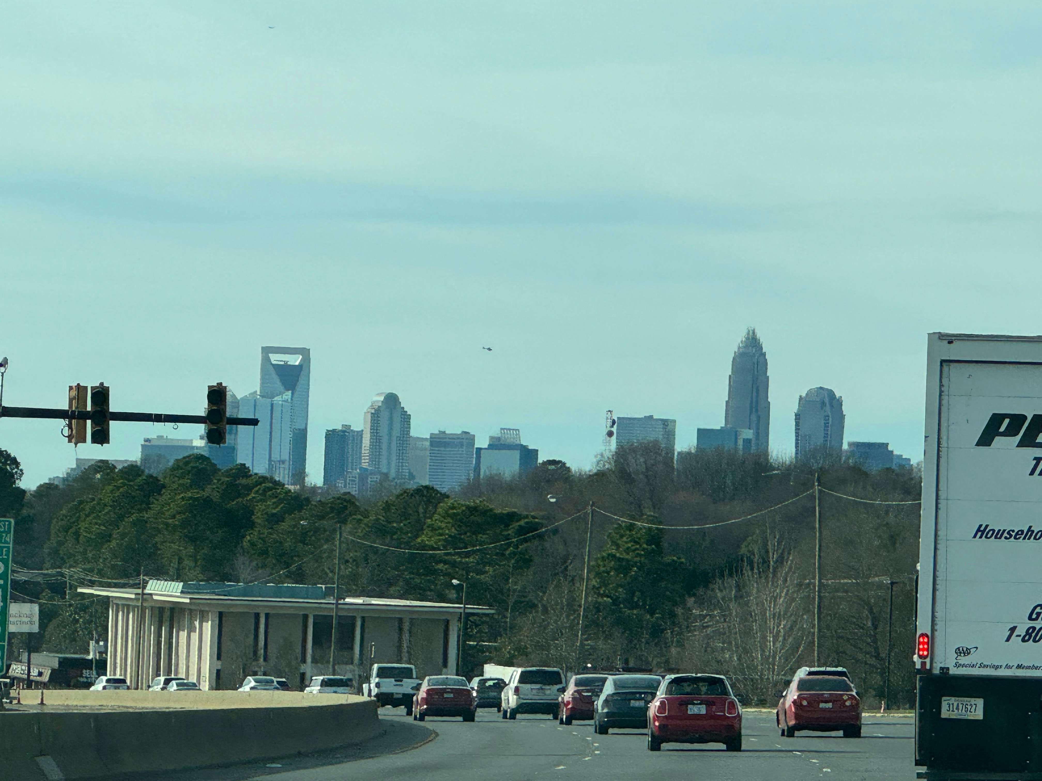 a truck is driving down the road in front of a city