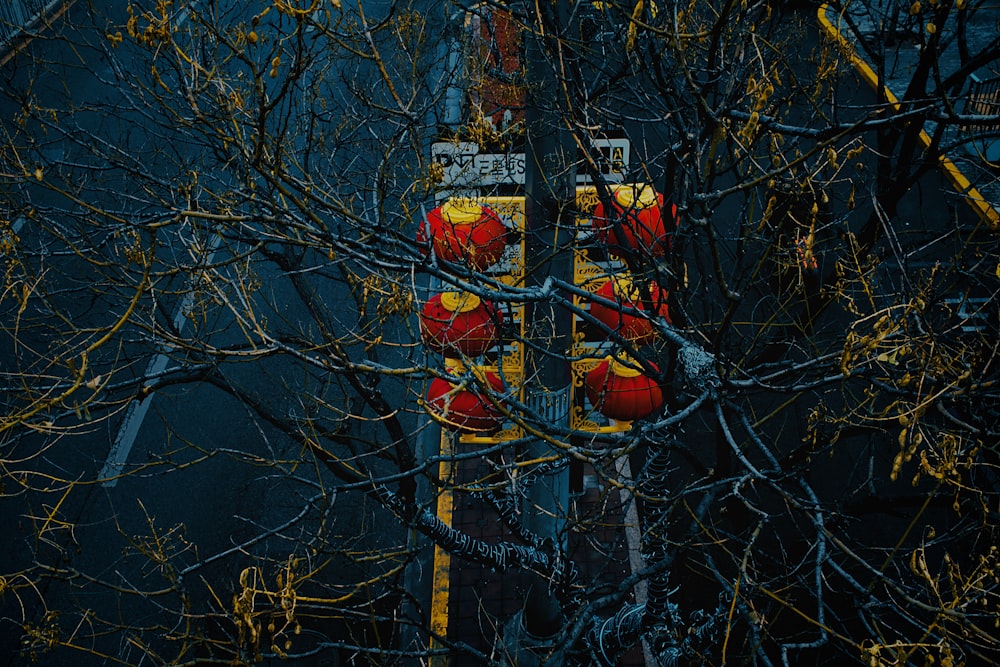 a street sign with red hearts on it next to a tree