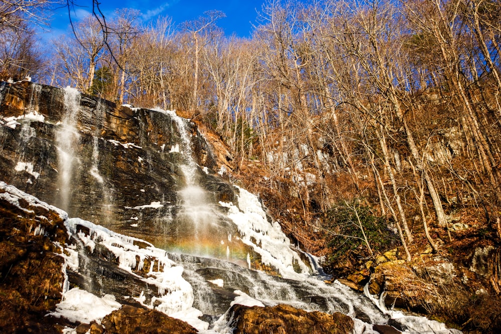 a waterfall with a rainbow in the middle of it