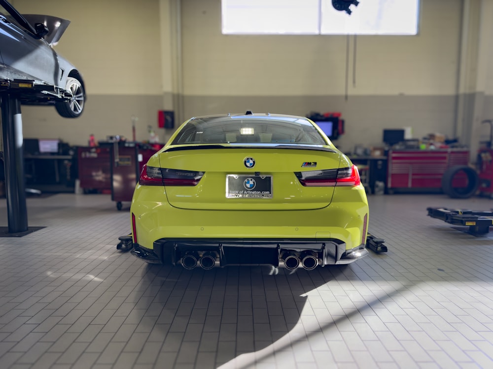 a yellow car is parked in a garage