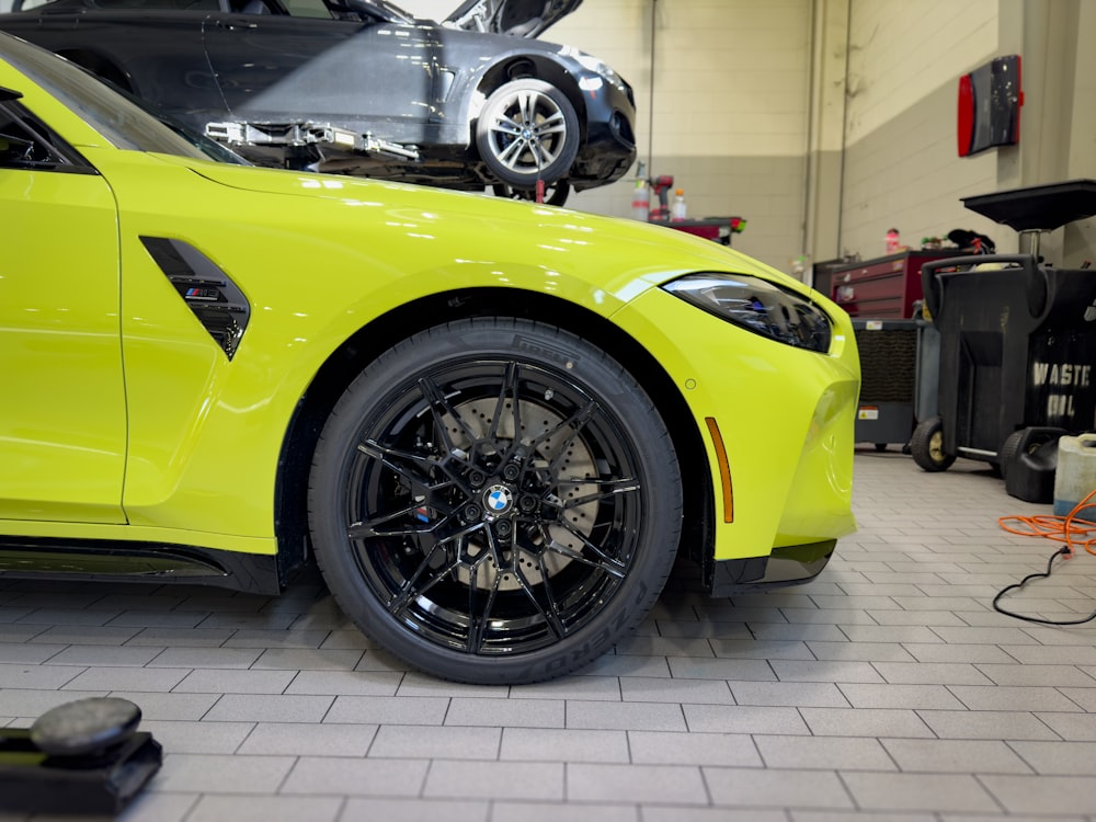 a yellow sports car parked in a garage