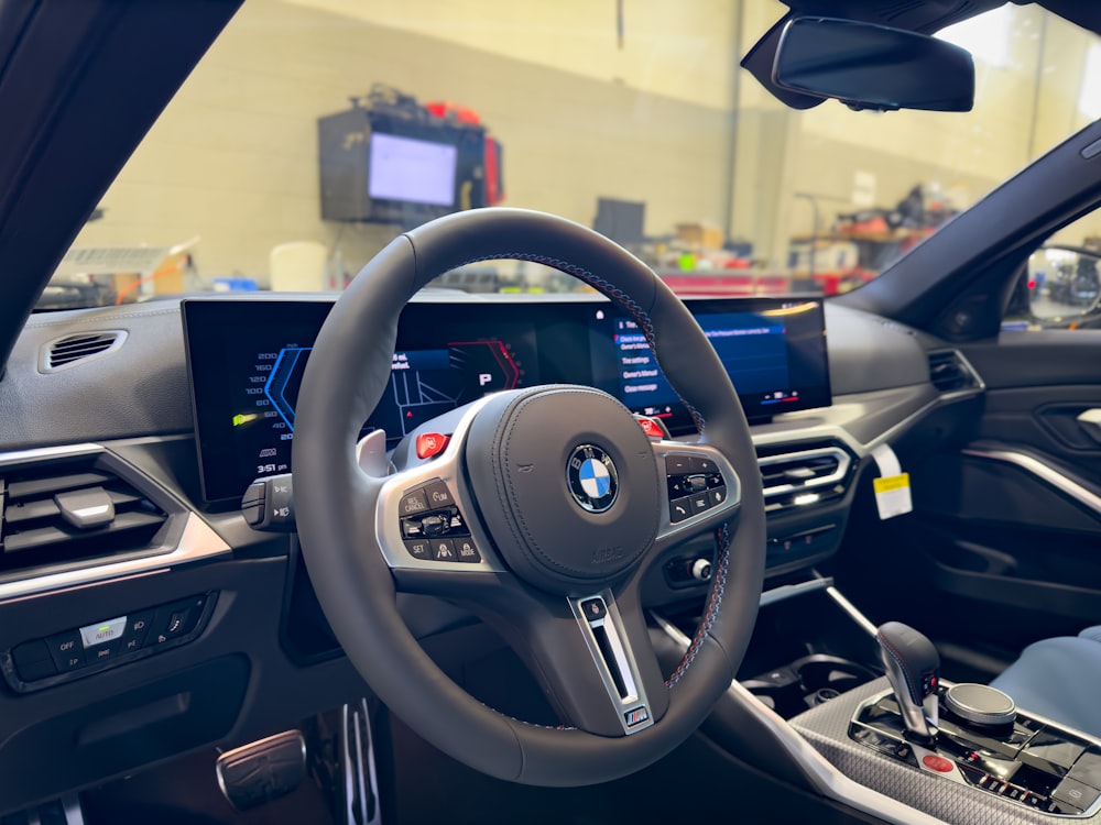 the interior of a car with a steering wheel and dashboard