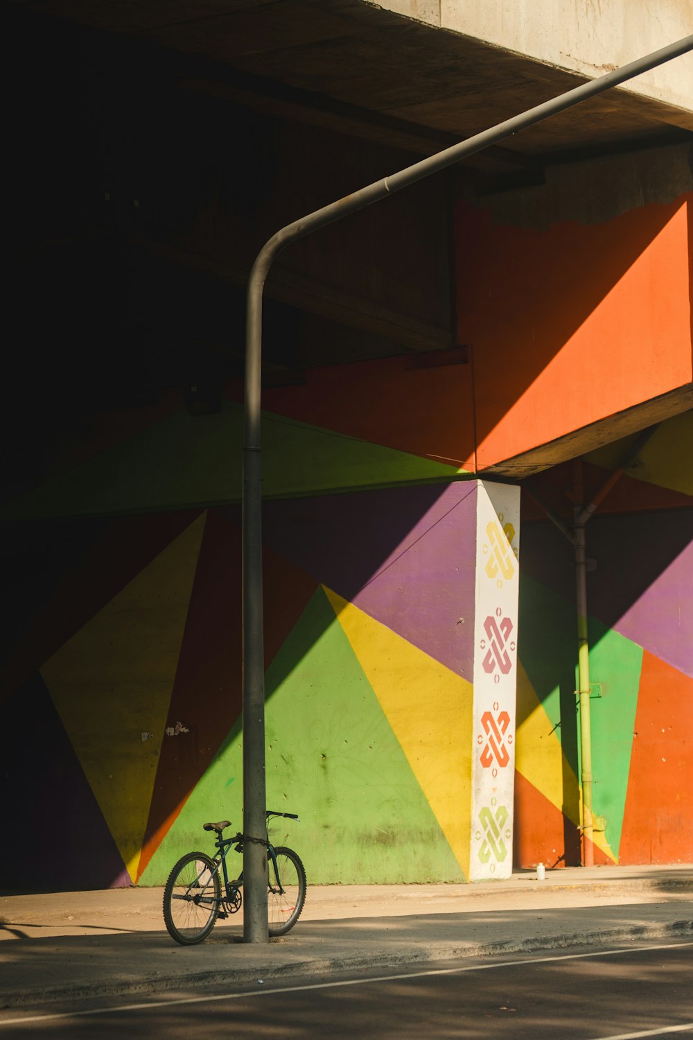 a bike parked in front of a colorful building