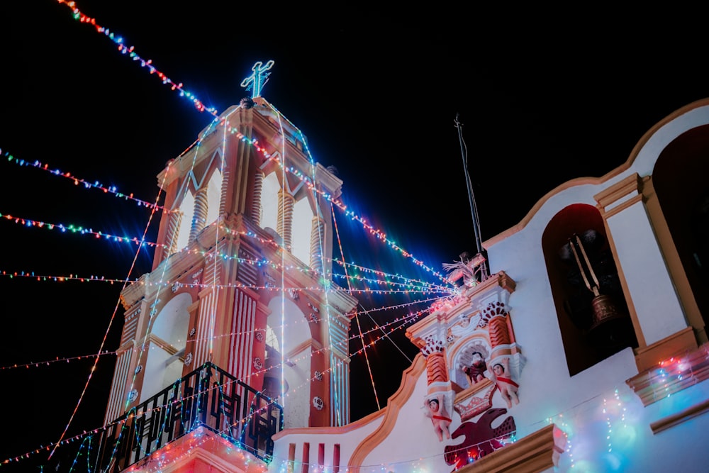 a building with a clock tower decorated with christmas lights