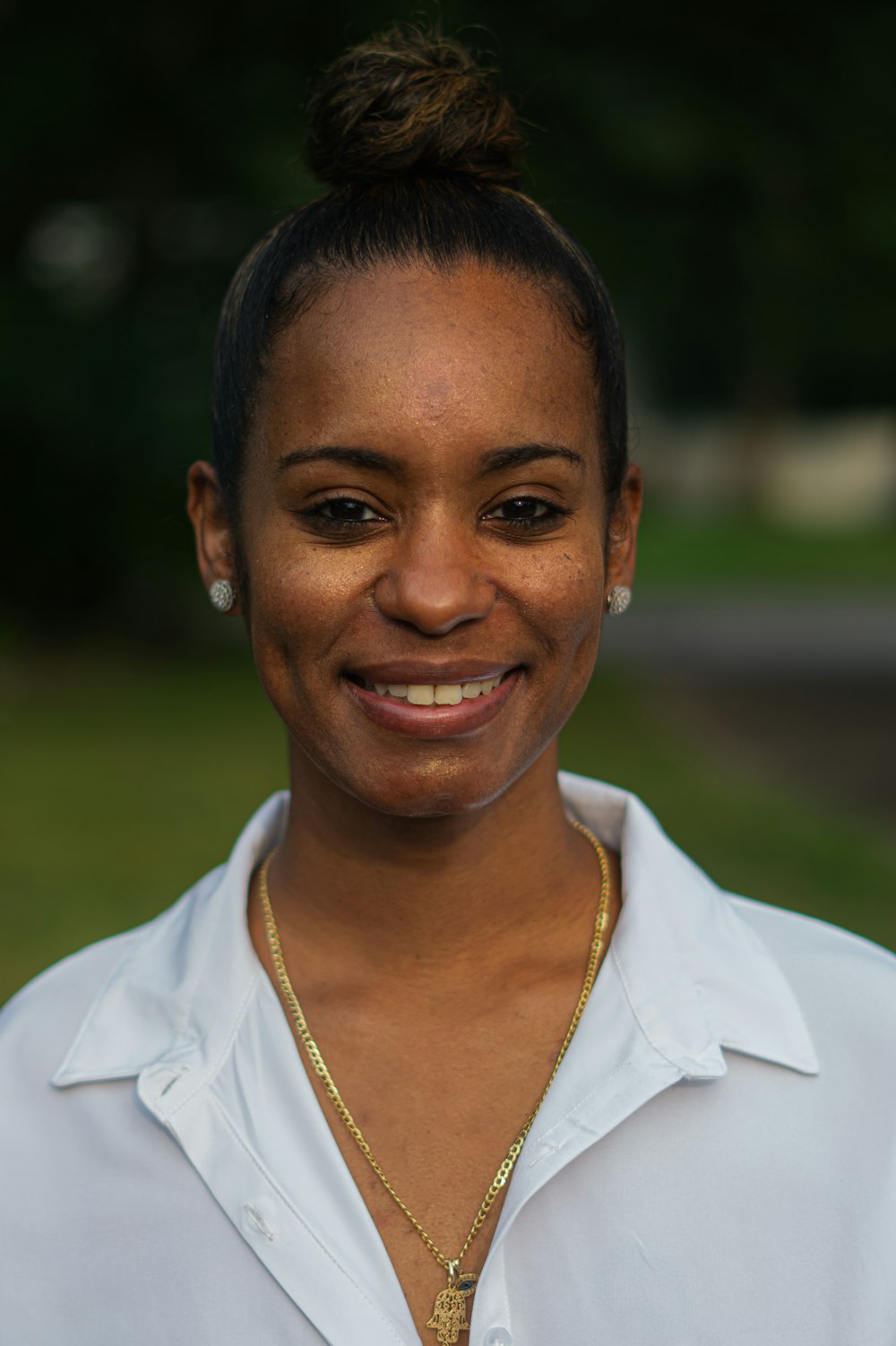 a woman in a white shirt is smiling