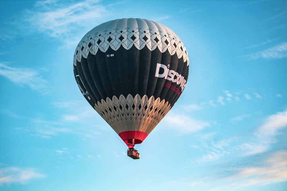 a large hot air balloon flying through a blue sky