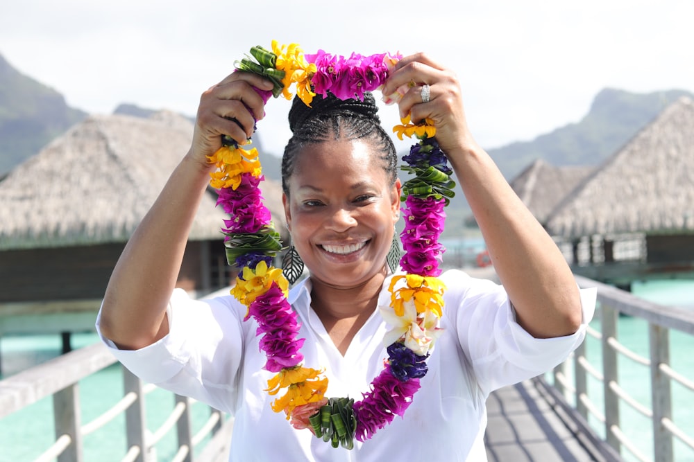 a woman holding a bunch of flowers in front of her face