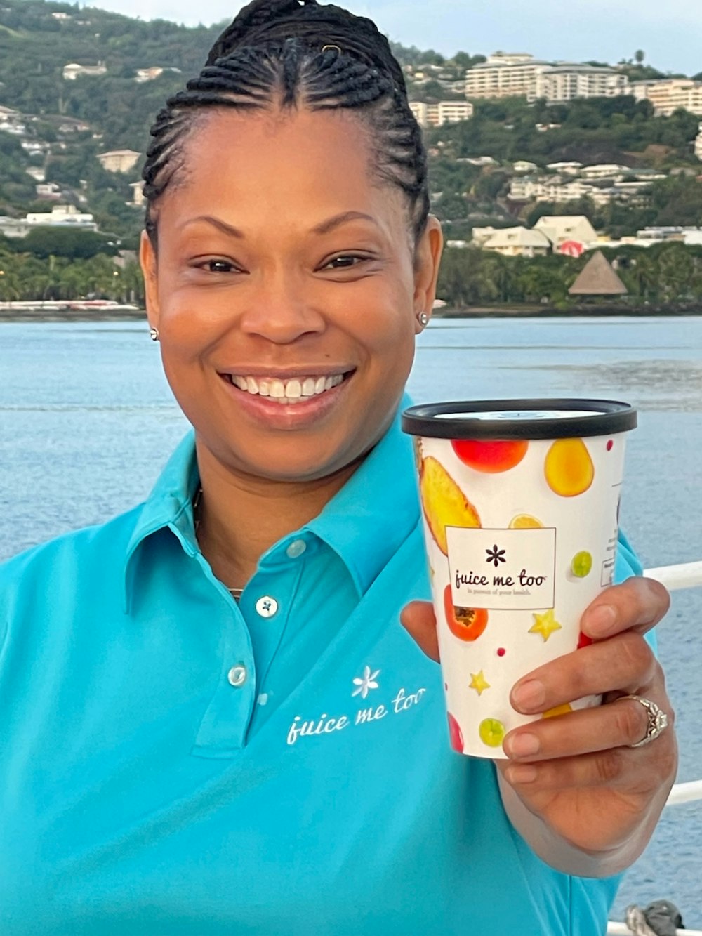 a woman holding a cup of coffee on a boat