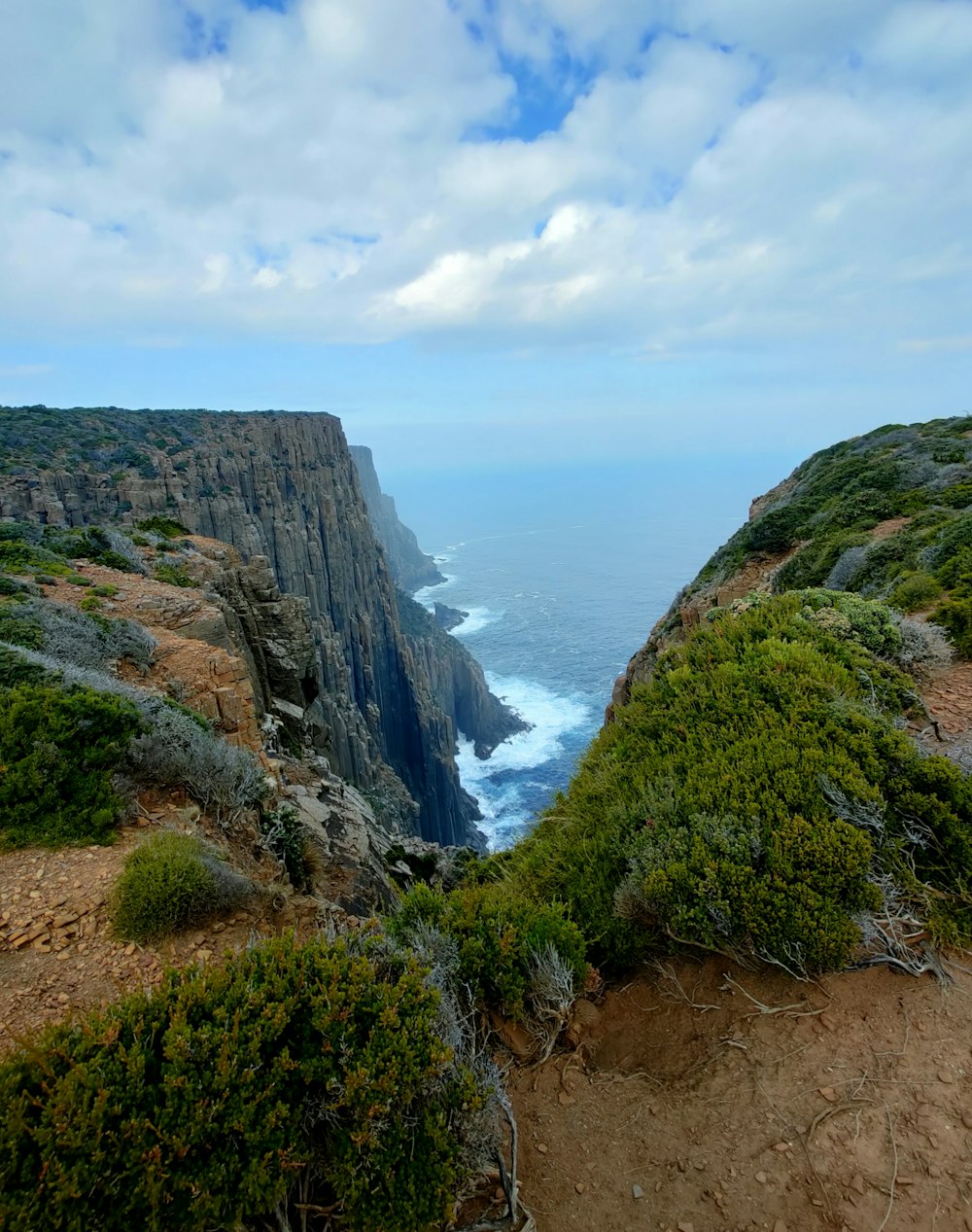 a view of the ocean from the top of a cliff