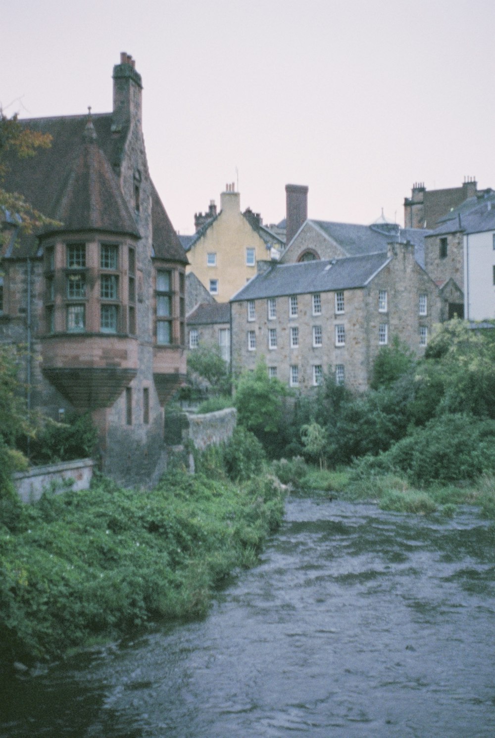 a river running through a city next to tall buildings