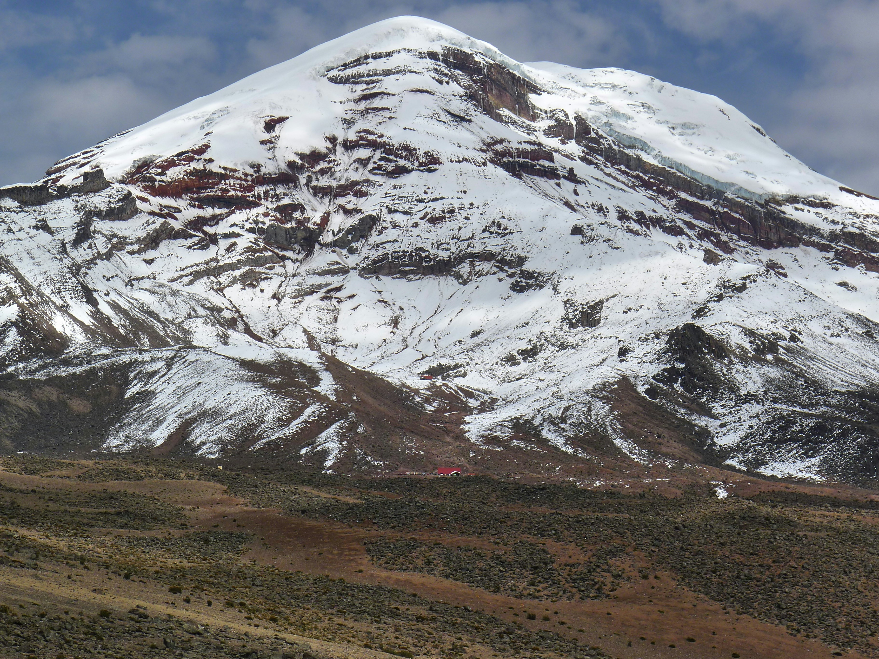 a large snow covered mountain in the distance