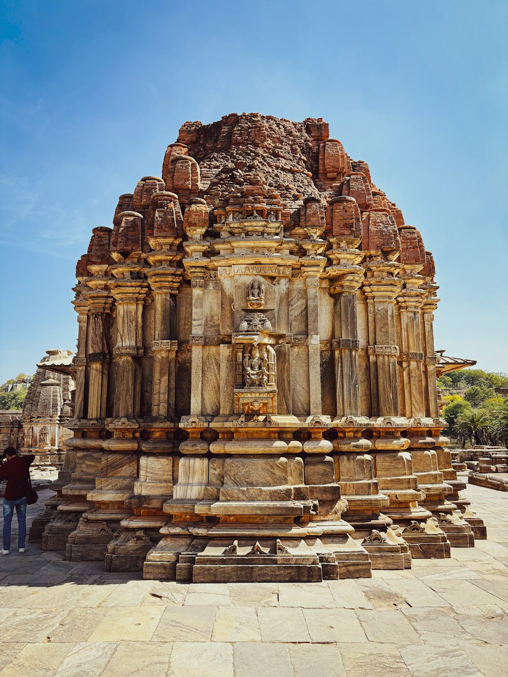 a person standing in front of a stone structure