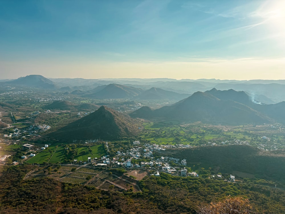 an aerial view of a town and mountains