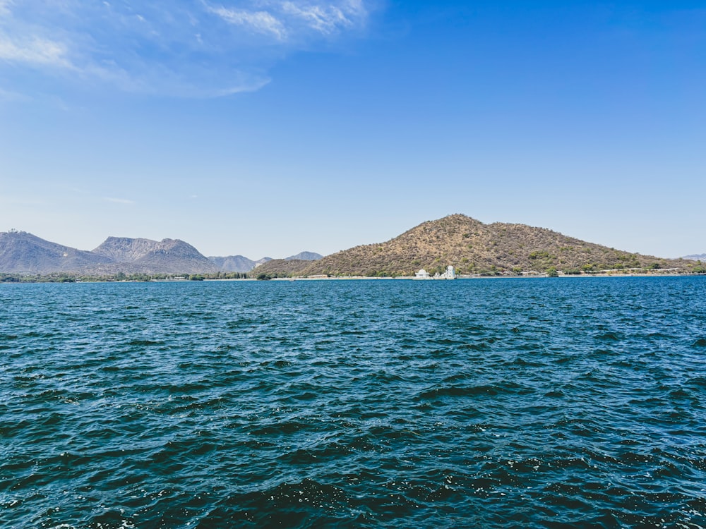 a large body of water with mountains in the background