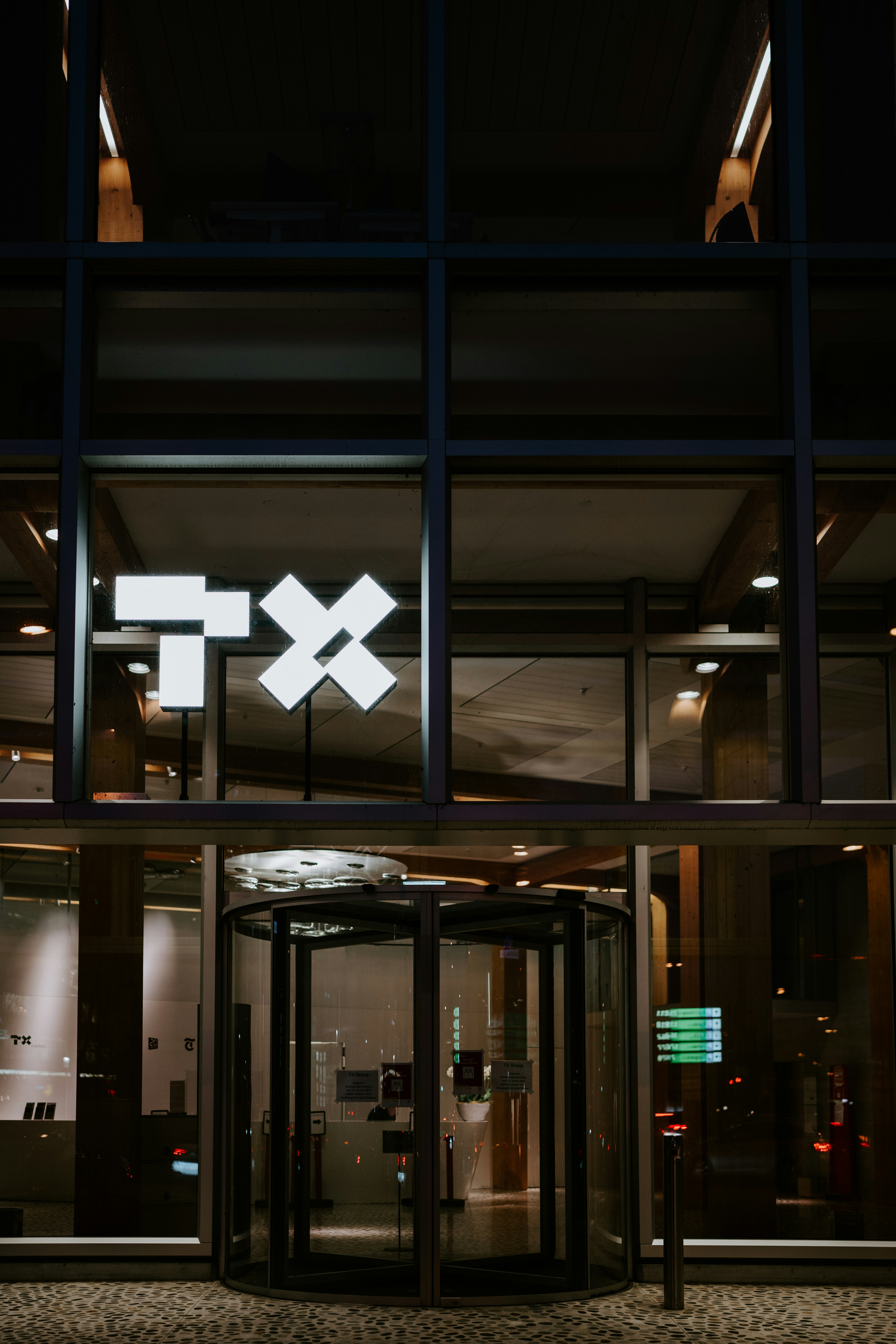 A building with a lit up exit way at night photo – Free Zurich Image on ...