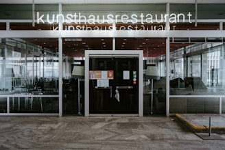 the entrance to a restaurant with glass doors