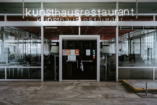 the entrance to a restaurant with glass doors