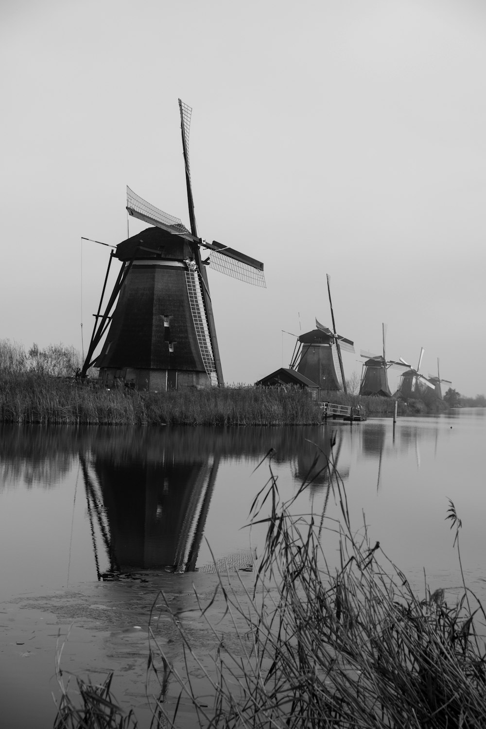 a group of windmills sitting on top of a lake